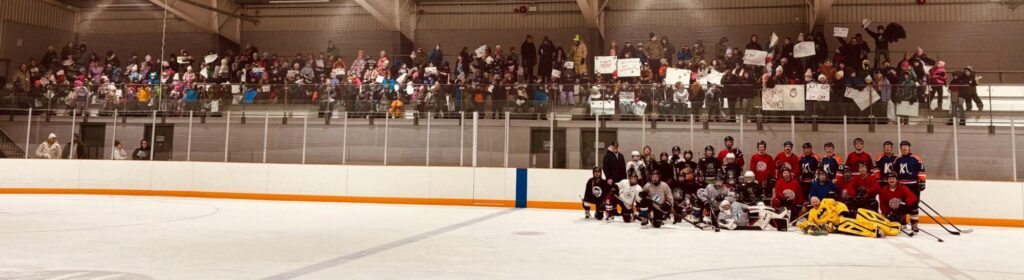 Woodsville Elementary School competes against local emergency services in a friendly game of hockey